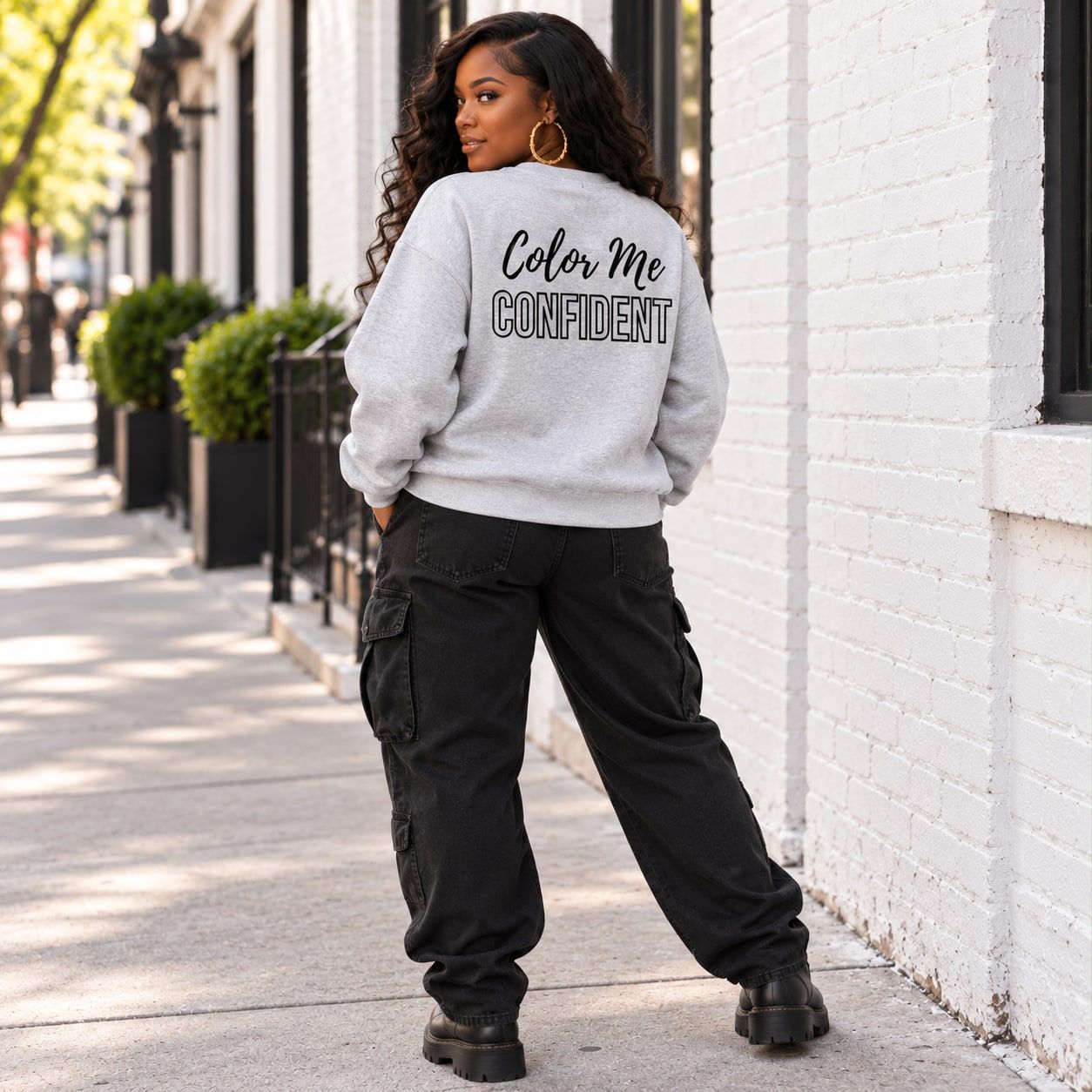 Woman in the ash grey Color Me Confident crewneck, back view