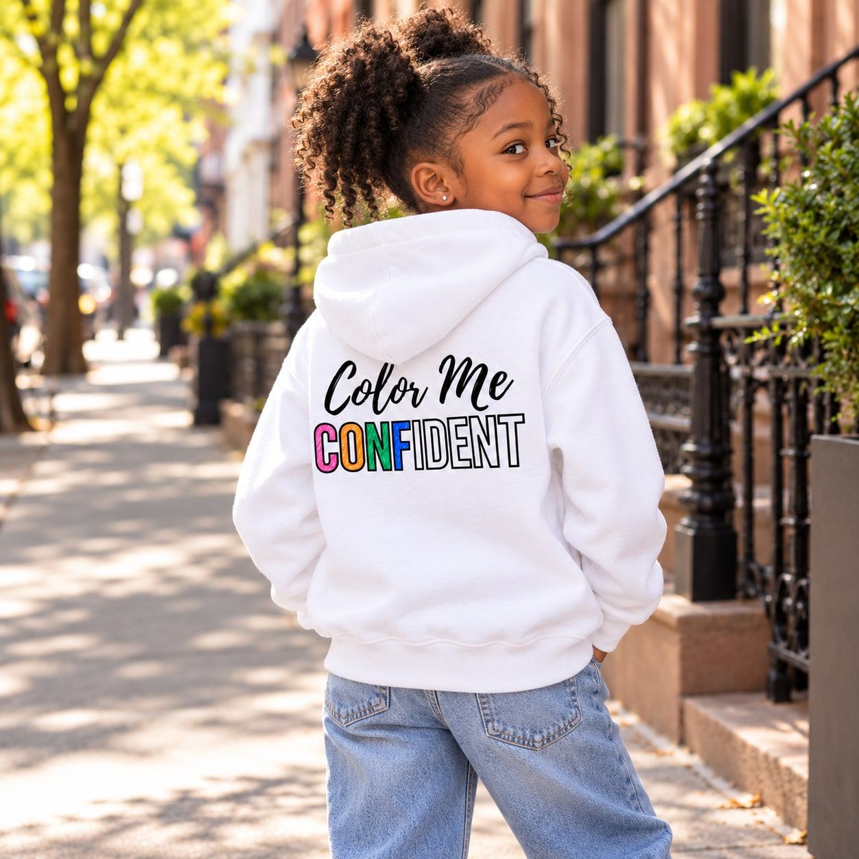 Girl in the white youth hoodie with her colored-in CONFIDENT letters