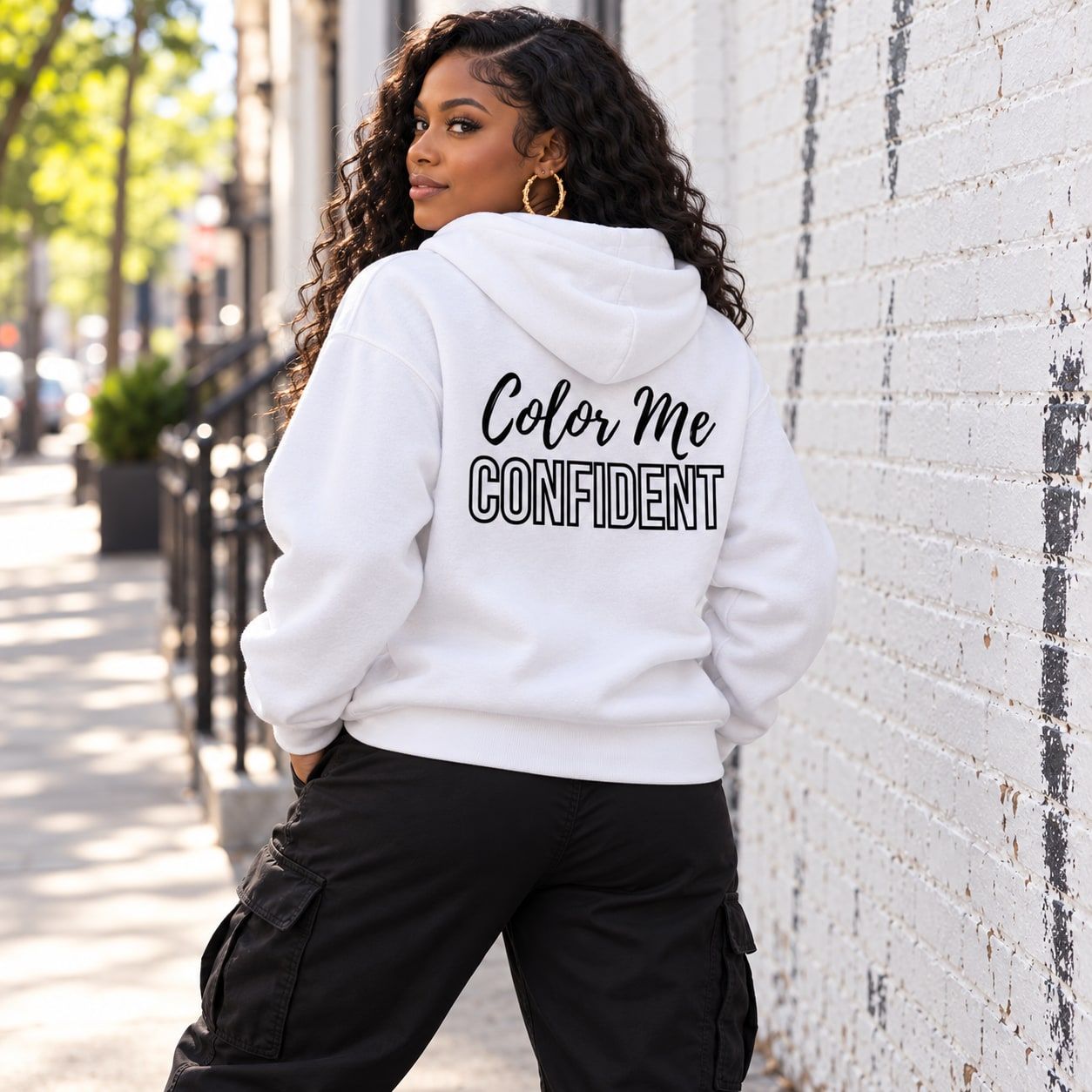 Woman in the white Color Me Confident hoodie, back view